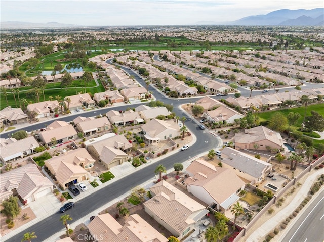 birds eye view of property with a water and mountain view