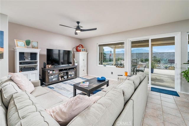 living room featuring light tile patterned floors and ceiling fan