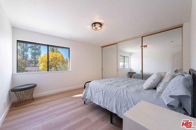 bedroom featuring a closet and light hardwood / wood-style flooring