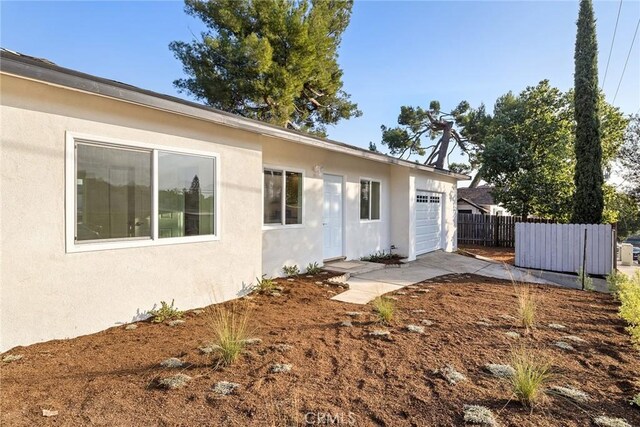 back of property featuring a garage