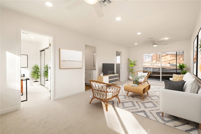 carpeted living room featuring ceiling fan