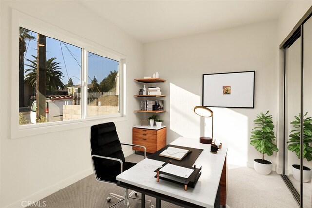 home office with plenty of natural light and carpet