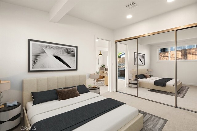 bedroom with beam ceiling and a closet