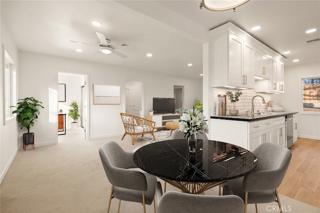 dining area with sink and ceiling fan