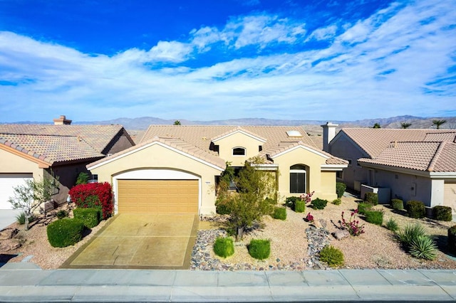 view of front facade featuring a garage and a mountain view