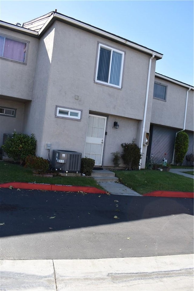 1718 Puente Ave Unit 40, Baldwin Park, CA 91706 - view of front facade featuring central AC and stucco siding