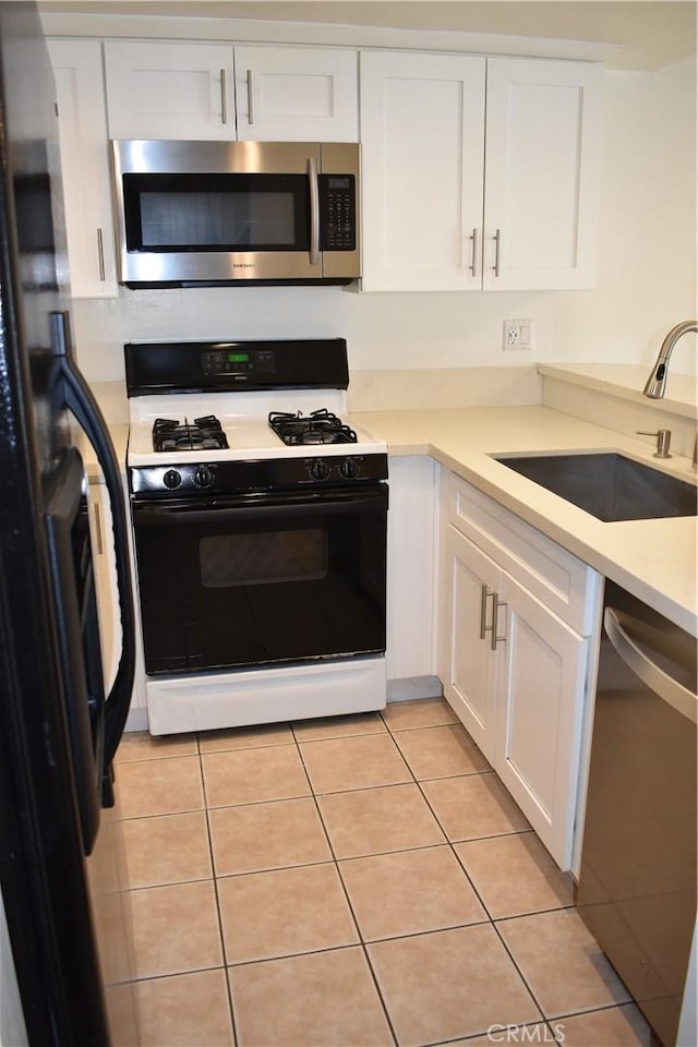 1718 Puente Ave Unit 40, Baldwin Park, CA 91706 - kitchen featuring stainless steel appliances, a sink, white cabinets, light countertops, and light tile patterned flooring