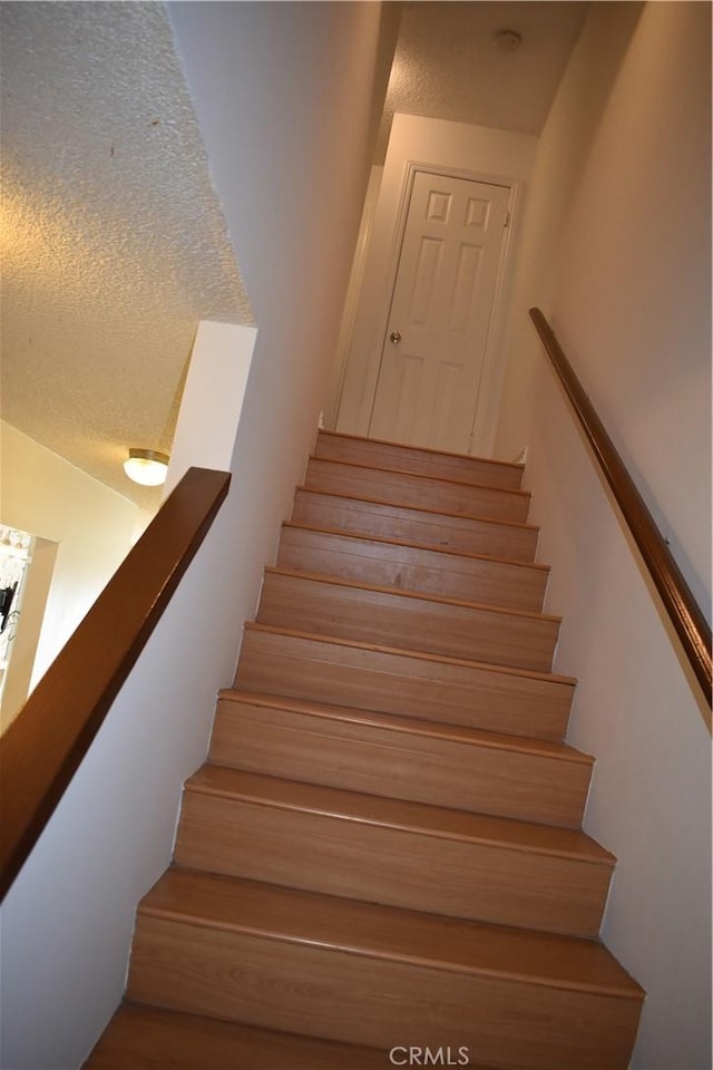 1718 Puente Ave Unit 40, Baldwin Park, CA 91706 - stairs featuring a textured ceiling
