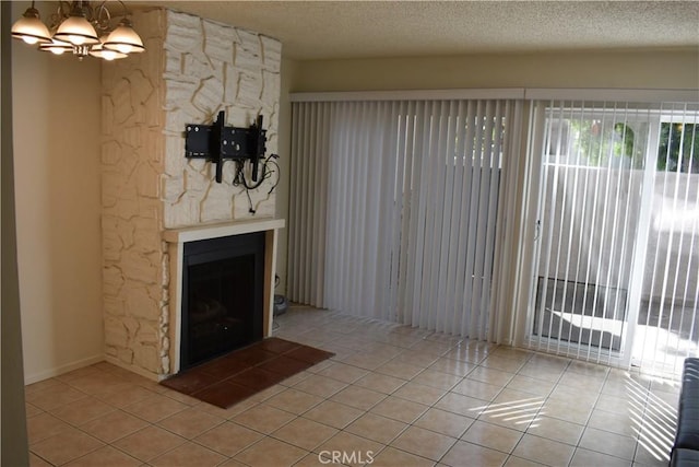 1718 Puente Ave Unit 40, Baldwin Park, CA 91706 - unfurnished living room with light tile patterned floors, a textured ceiling, a chandelier, and a large fireplace