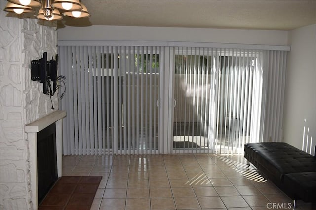 1718 Puente Ave Unit 40, Baldwin Park, CA 91706 - tiled living area featuring a fireplace and a chandelier