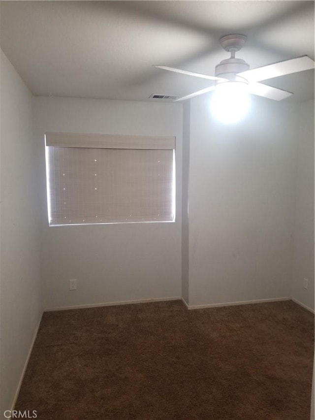 empty room with carpet floors, ceiling fan, and visible vents