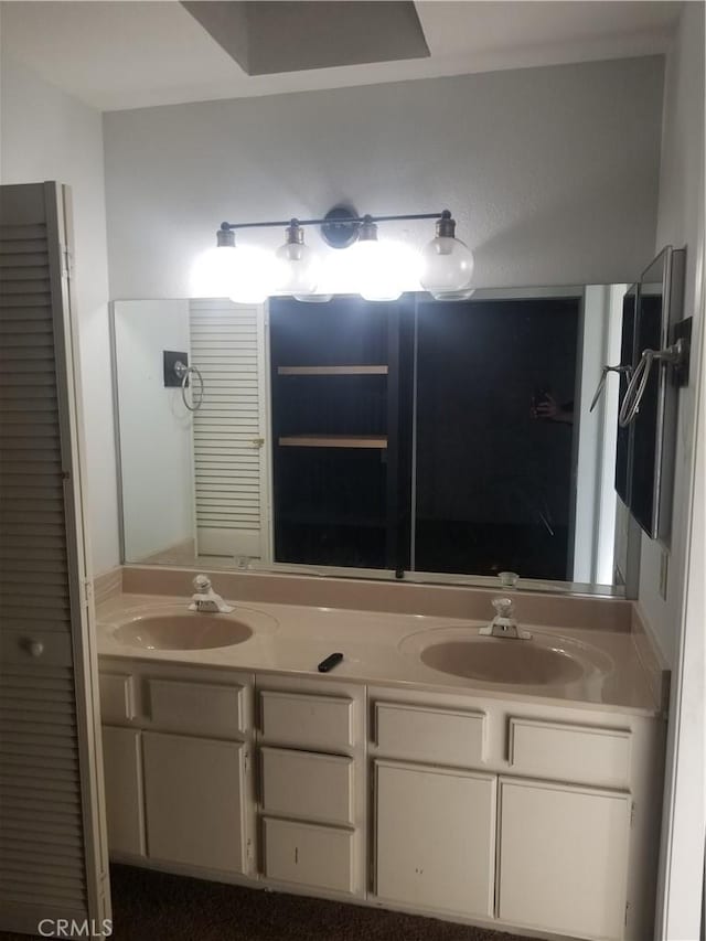 full bathroom featuring double vanity and a sink