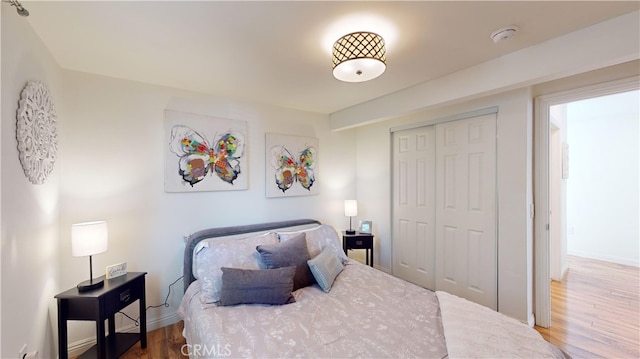 bedroom featuring hardwood / wood-style flooring and a closet