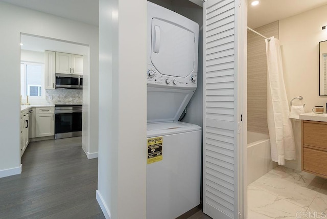 laundry room featuring stacked washer and clothes dryer