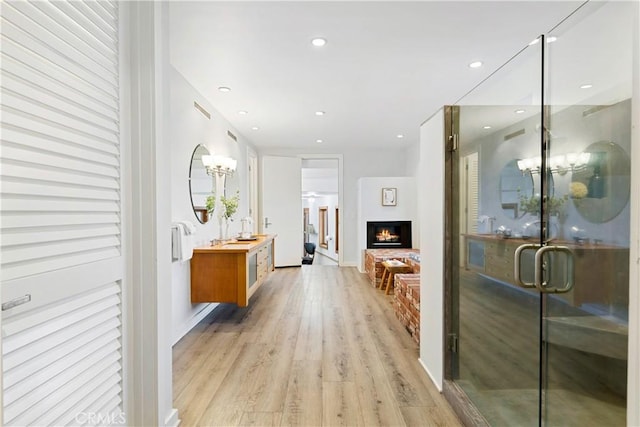 hallway with light hardwood / wood-style floors