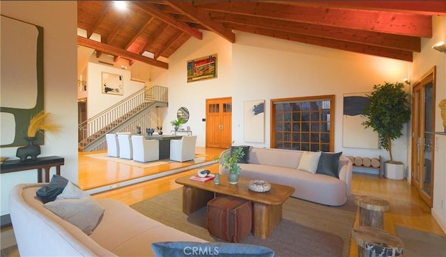 living room with hardwood / wood-style flooring, beamed ceiling, high vaulted ceiling, and wood ceiling