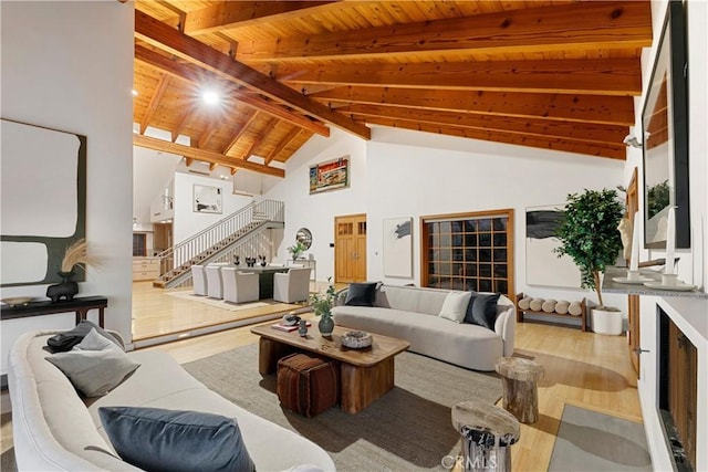 living room with high vaulted ceiling, hardwood / wood-style floors, beam ceiling, and wood ceiling