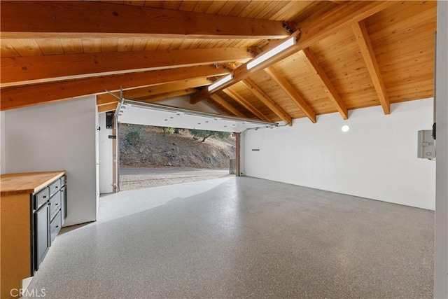 interior space featuring lofted ceiling with beams and wooden ceiling