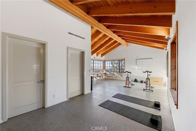 exercise area with high vaulted ceiling and wooden ceiling