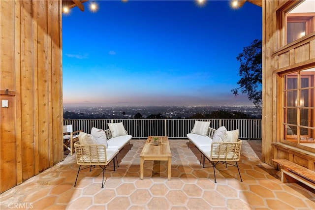 patio terrace at dusk featuring an outdoor living space