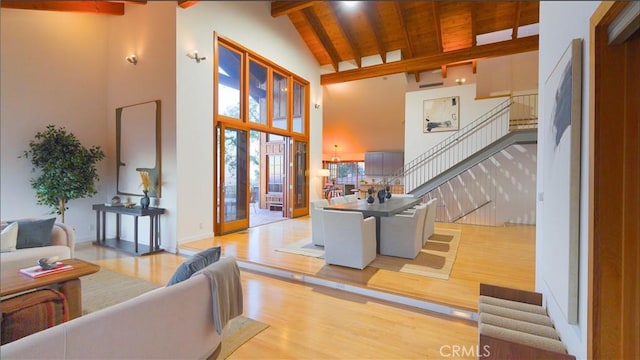 living room with light wood-type flooring, wooden ceiling, beam ceiling, and high vaulted ceiling