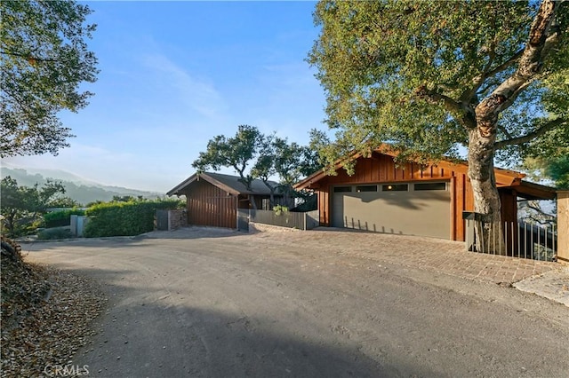 view of front of property with an outbuilding, a mountain view, and a garage