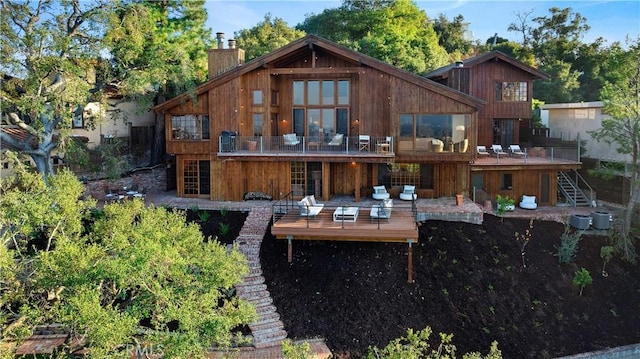 back of property featuring a wooden deck