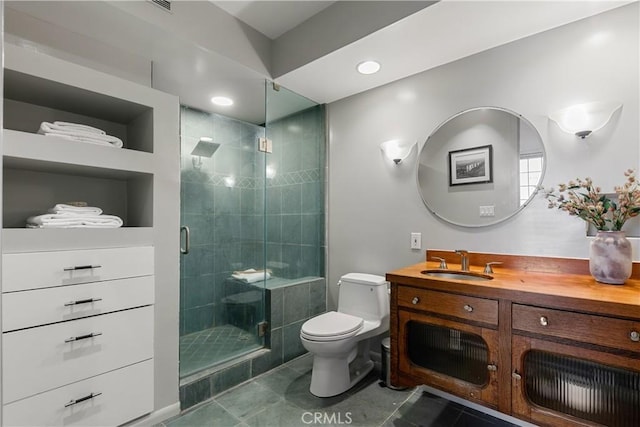 bathroom featuring a shower with shower door, vanity, and toilet