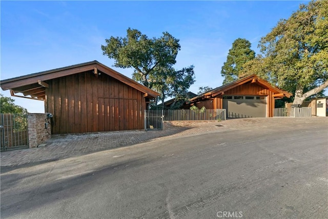 exterior space featuring a garage and an outdoor structure