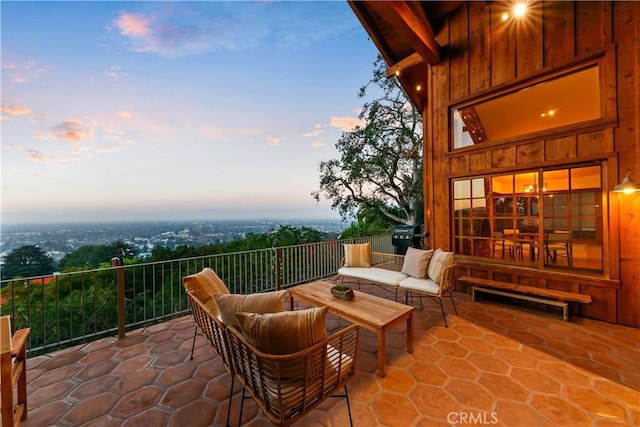 patio terrace at dusk featuring an outdoor living space