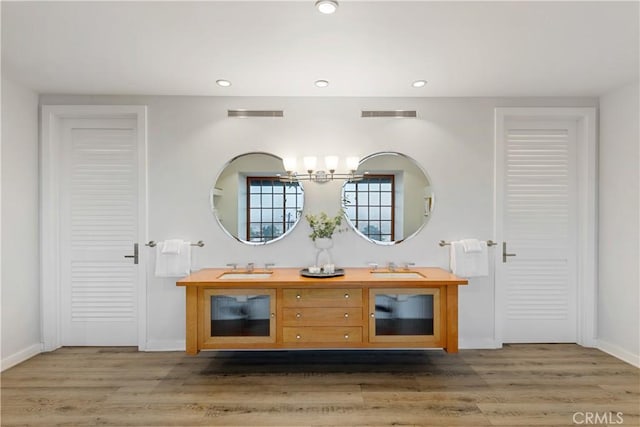 bathroom featuring a chandelier, hardwood / wood-style flooring, and vanity