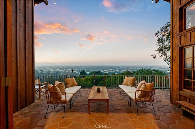 patio terrace at dusk featuring an outdoor living space