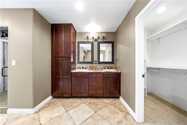 bathroom featuring vanity and a shower with door