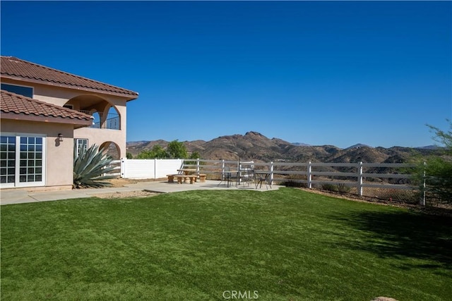 view of yard featuring a patio area and a mountain view