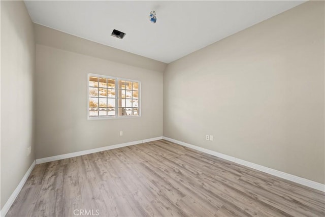 empty room with light hardwood / wood-style flooring