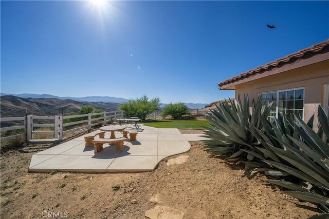 view of yard featuring a mountain view and a patio