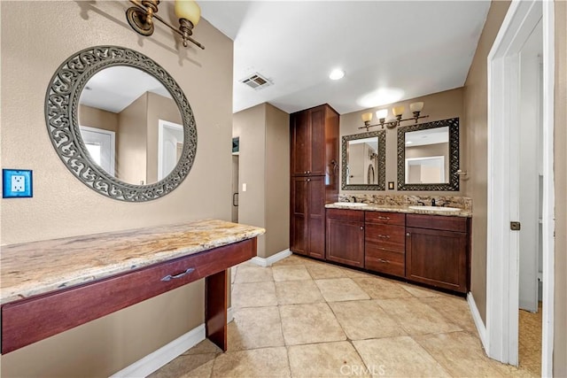 bathroom with tile patterned floors and vanity