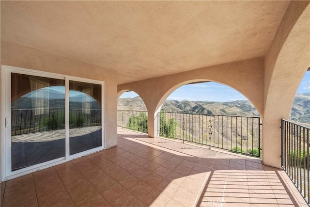 view of patio / terrace with a mountain view and a balcony