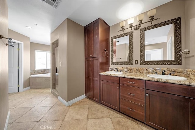 bathroom with separate shower and tub, vanity, and tile patterned floors