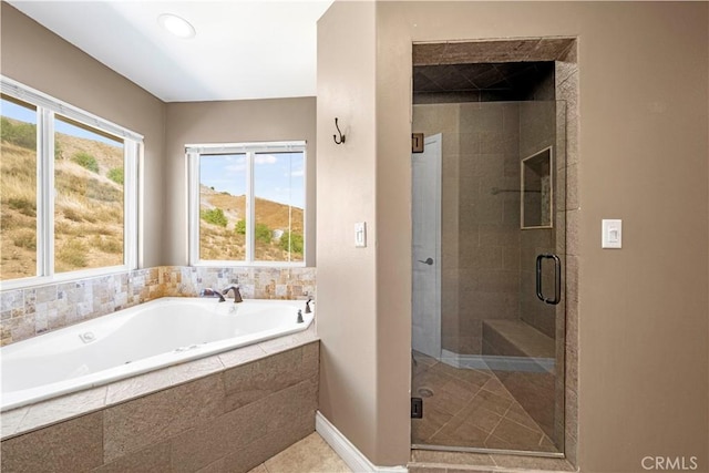 bathroom with tile patterned flooring and shower with separate bathtub