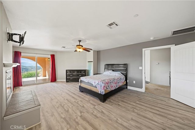 bedroom featuring ceiling fan, wood-type flooring, and access to outside