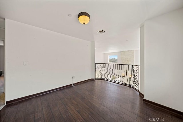 unfurnished room featuring dark wood-type flooring