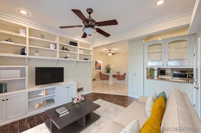 living room with dark hardwood / wood-style flooring and ornamental molding