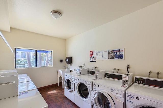 washroom with washer and dryer and sink