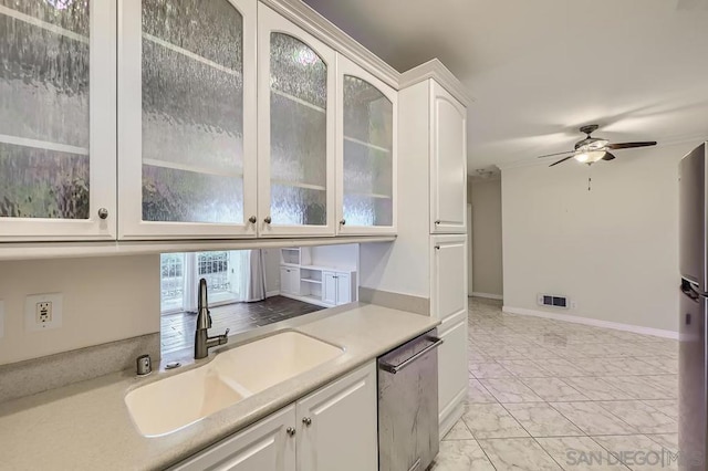 kitchen featuring ceiling fan, sink, white cabinets, and stainless steel appliances