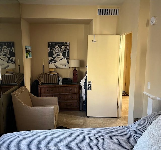 bedroom featuring light tile patterned floors and visible vents