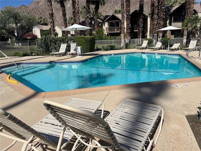 view of pool with a mountain view and a patio