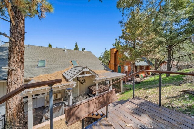 wooden deck with a lawn