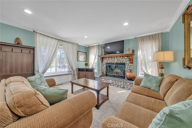 living room featuring ornamental molding, light carpet, and a fireplace