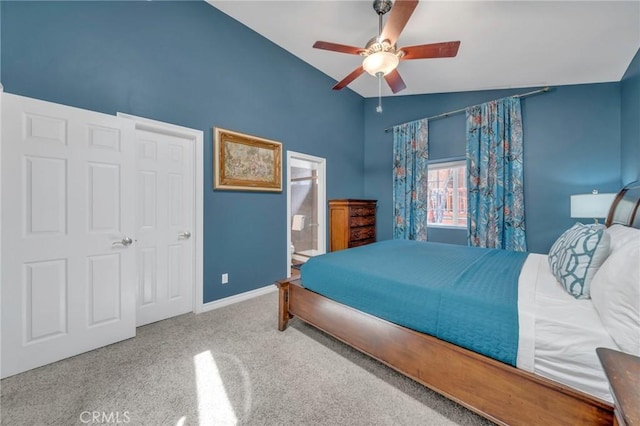 bedroom with ceiling fan, carpet floors, ensuite bath, a closet, and lofted ceiling